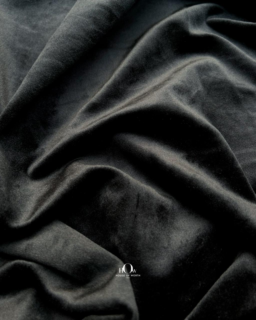 Close-up of plush black velvet fabric texture with rich sheen