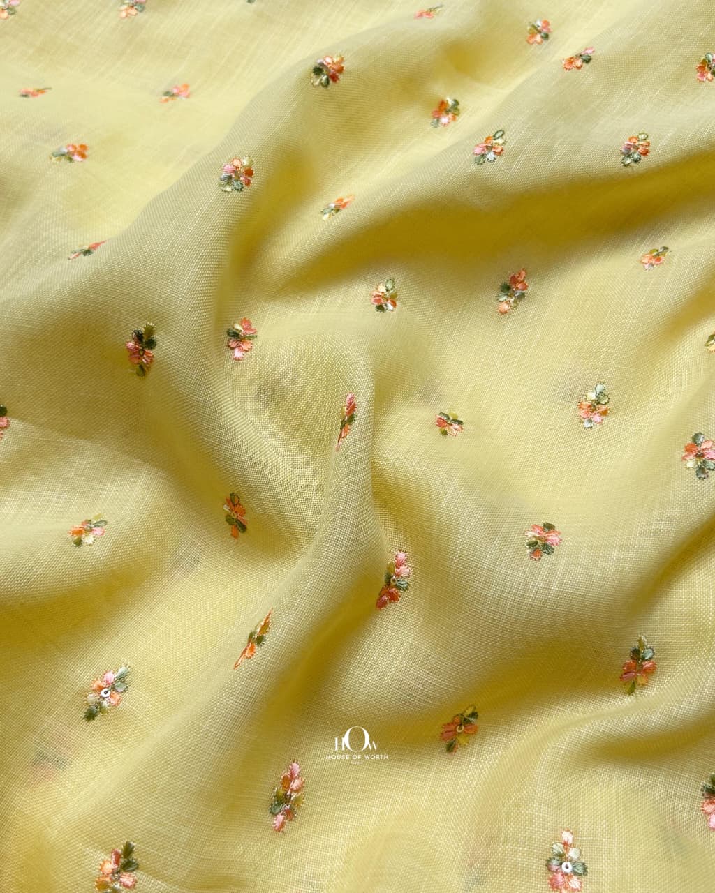 butter yellow floral embroidered linen fabric designed for premium summer and festive outfits.