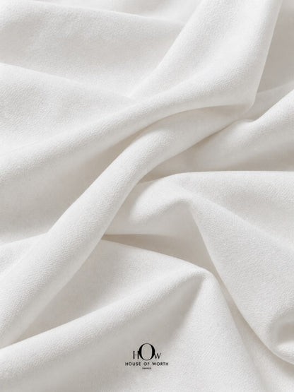 White dyeable denim fabric with a clean white surface and structured folds