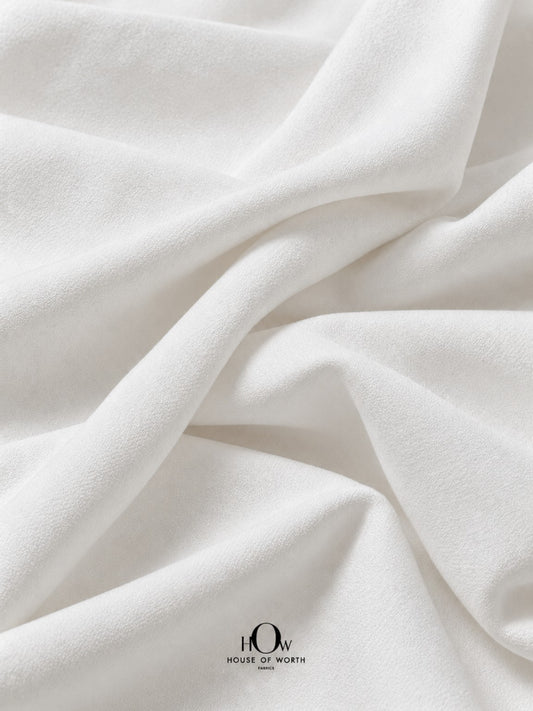 White dyeable denim fabric with a clean white surface and structured folds