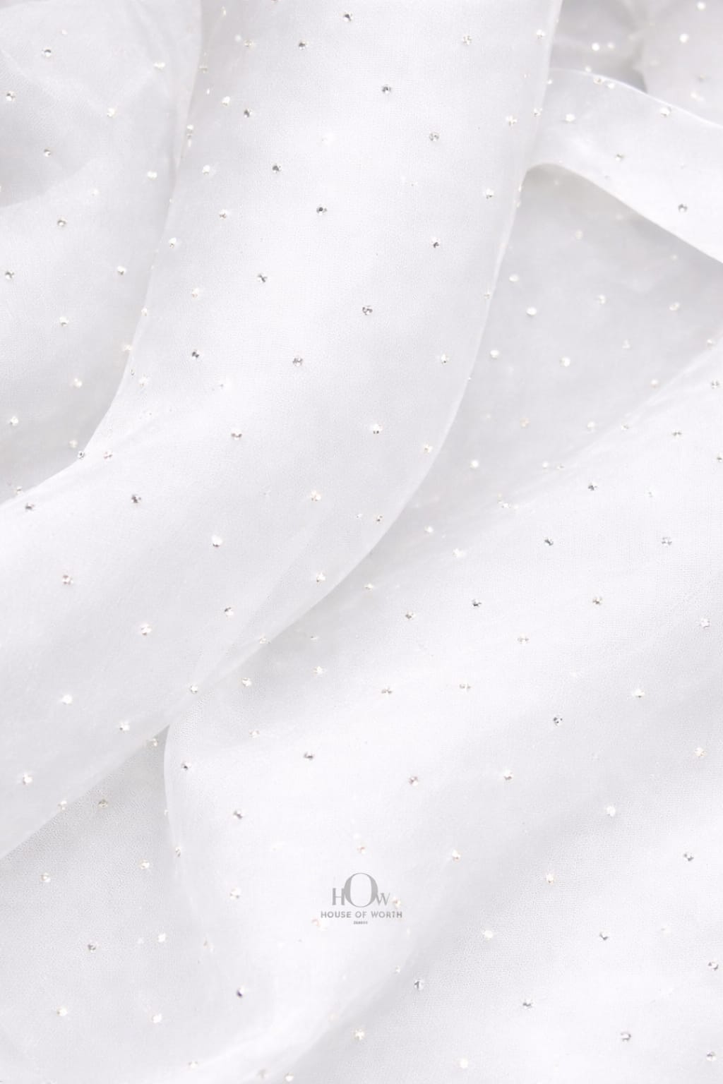 White organza material with glittering crystal embellishments