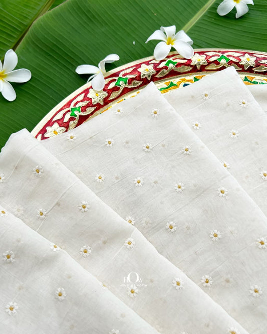 White Pure Mul Chanderi fabric with scattered small yellow floral buti embroidery
