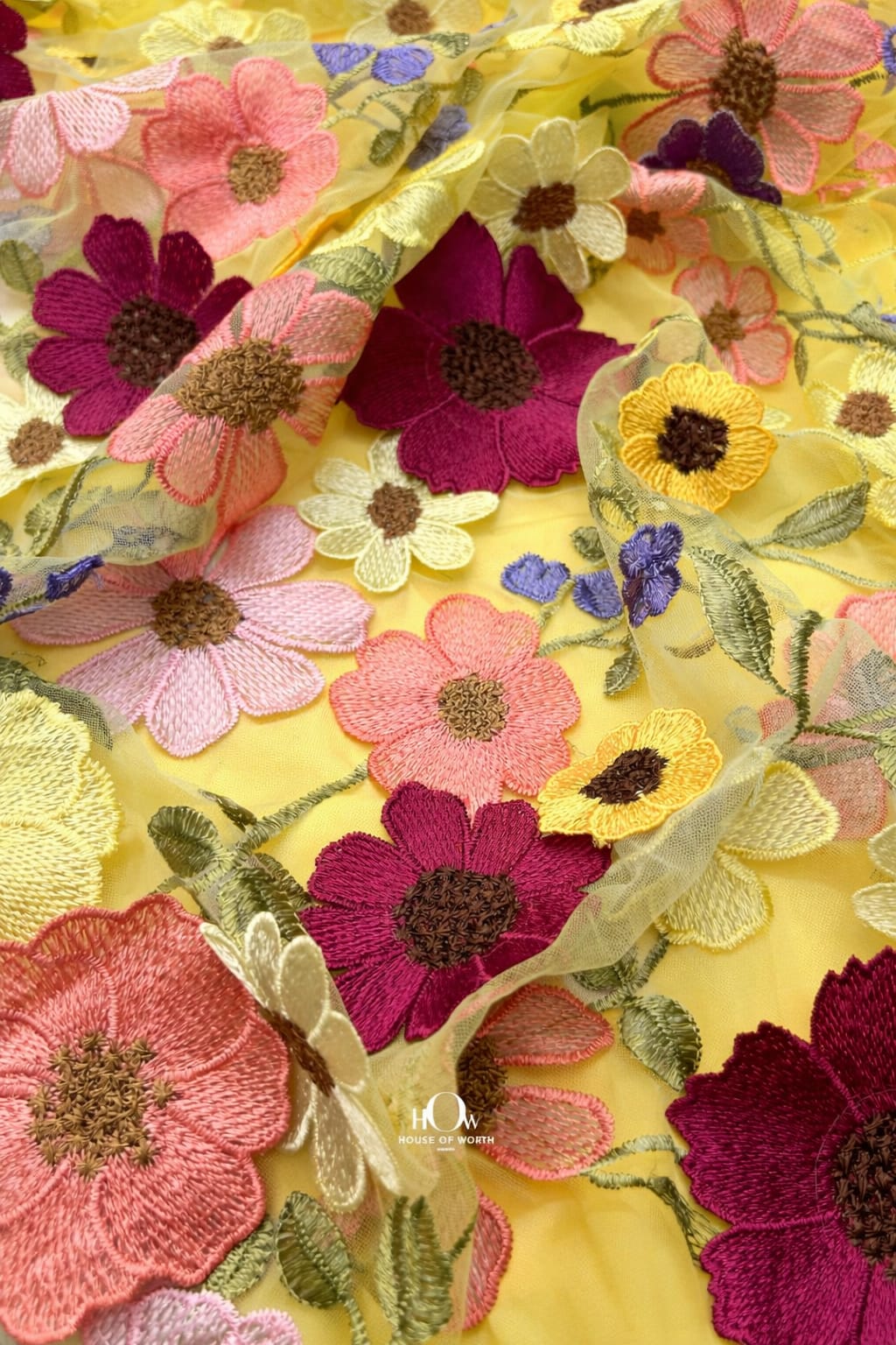 Yellow floral applique fabric close-up of raised petals on net, premium finish for couture dresses